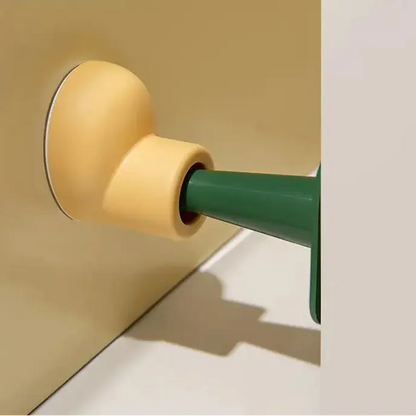 Close-up of a green door handle on a beige door