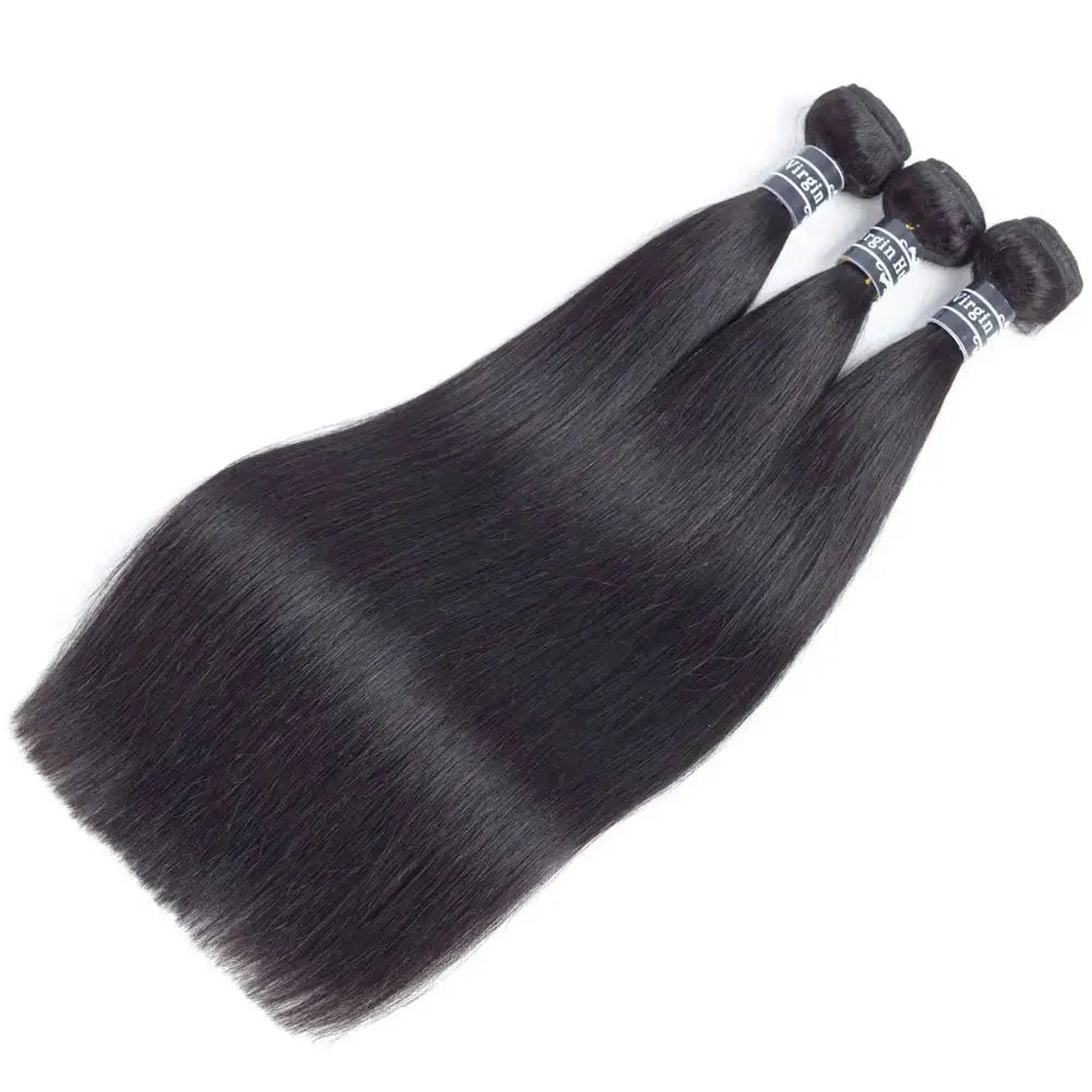 Three bundles of straight black hair on a white background
