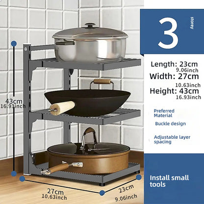 Three-tier kitchen storage rack with pots and pans on a tiled wall background