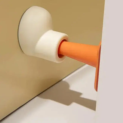 Close-up of an orange and beige door handle on a beige wall.