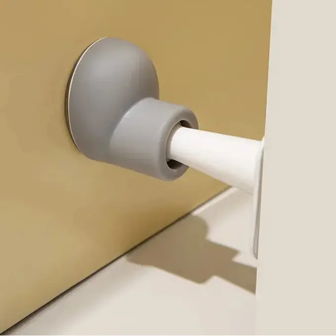 Curtain rod holder with gray and white design on a beige background