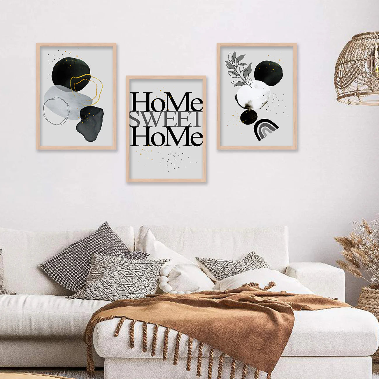 Living room with a white sofa, decorative pillows, and framed art on the wall.